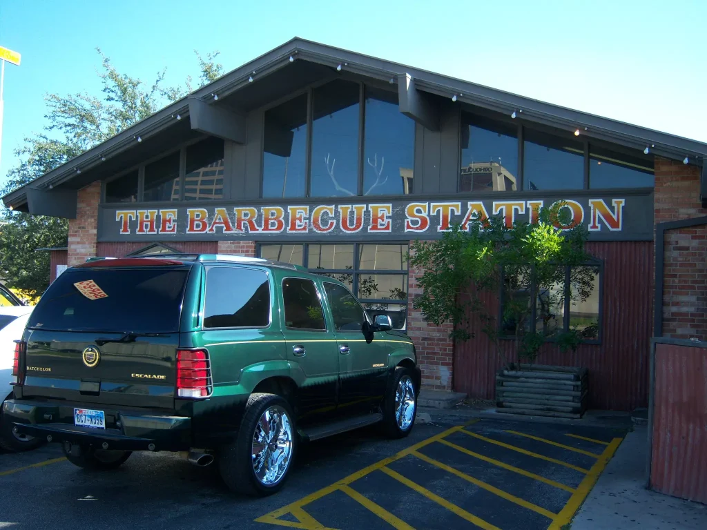 The Barbecue Station object with a green car parked infront of it