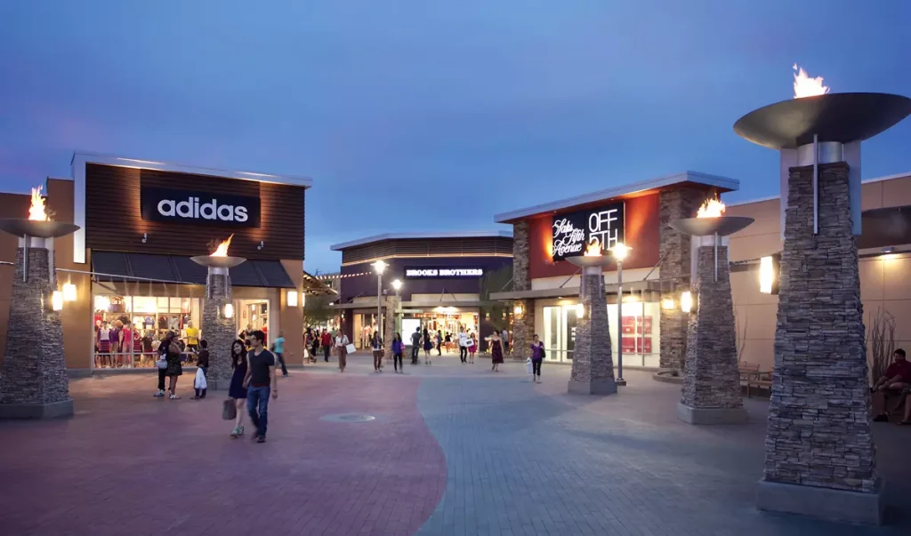 Phoenix premium outlets and people infront of the shops at night