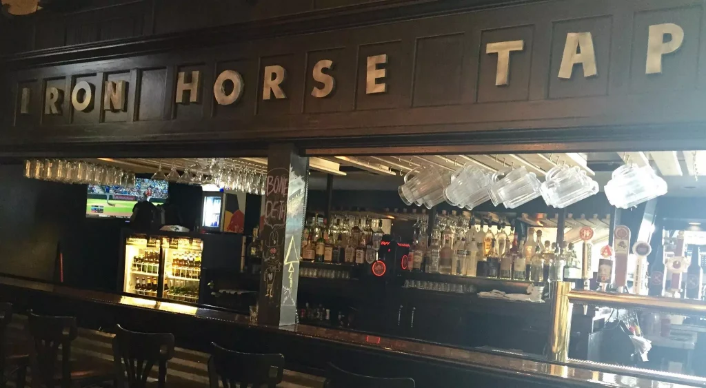 A bar with iron horse tap written above it