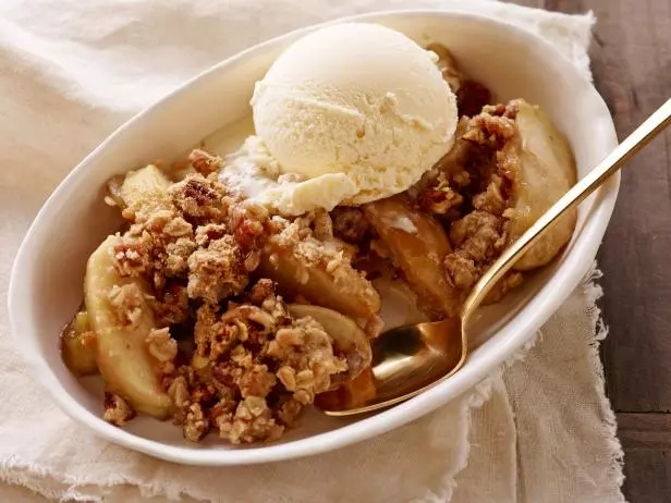 Mushed apples and ice cream in a white bowl 