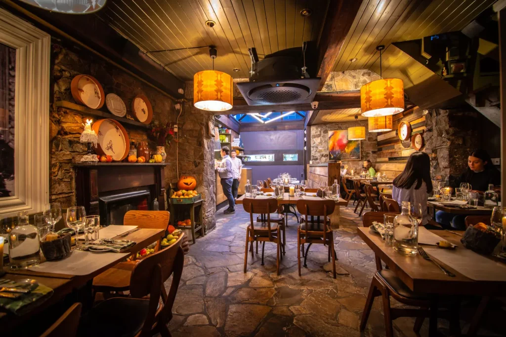 inside of a restaurant with yellow and orange lights