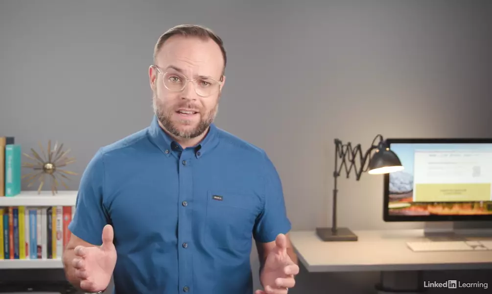 A man in a blue shirt and glasses