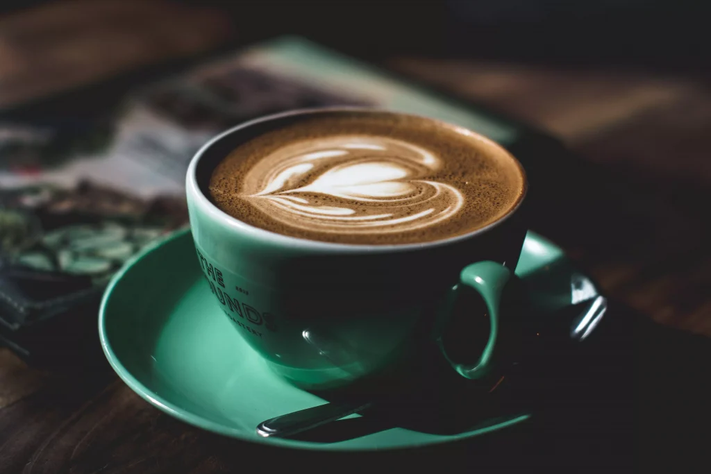 A cup of coffe with a heart shaped milk on top