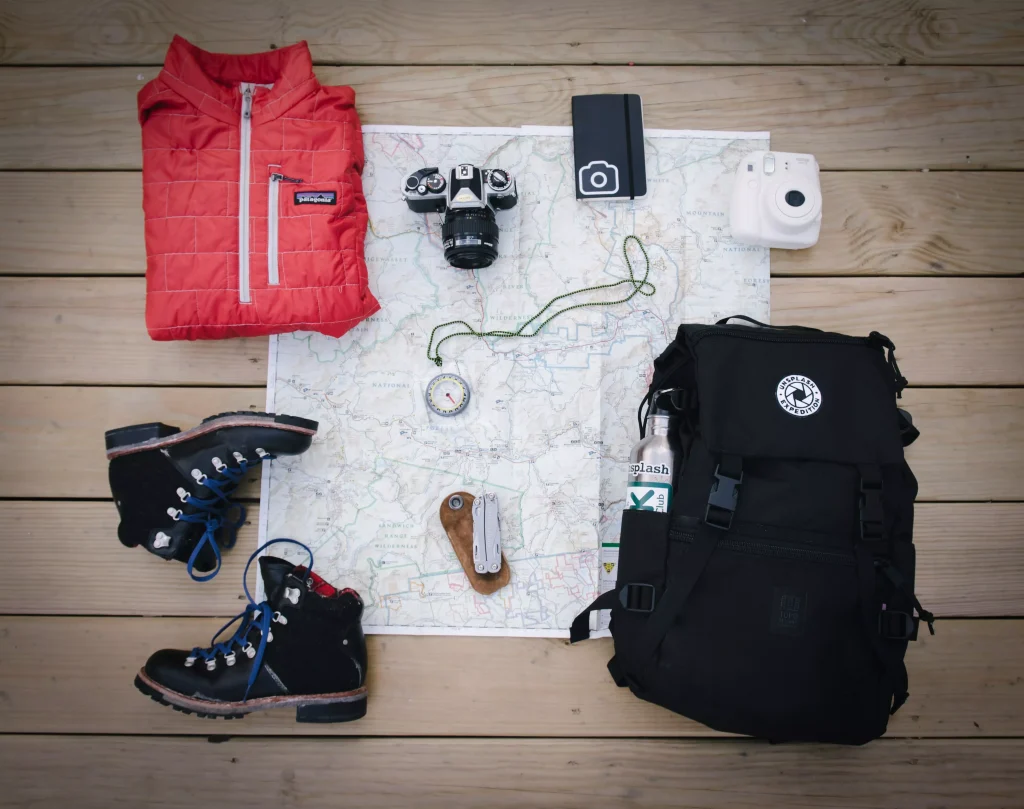 Bag, shoes, a camer, map, a backpack and a hoodie