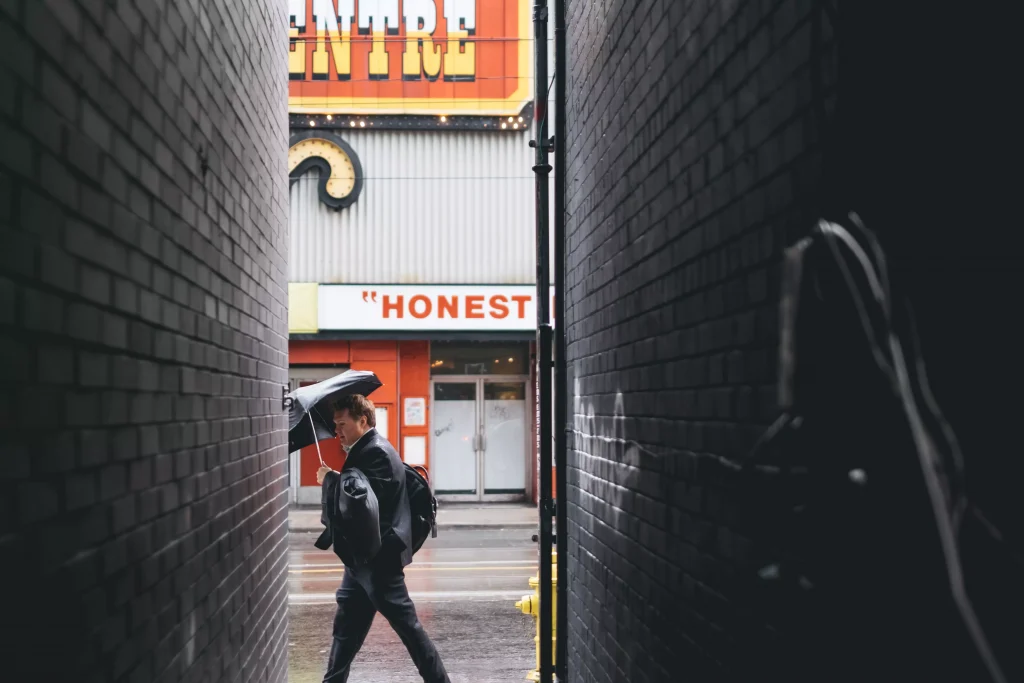 A rainy day in a town with a sign that says honest 