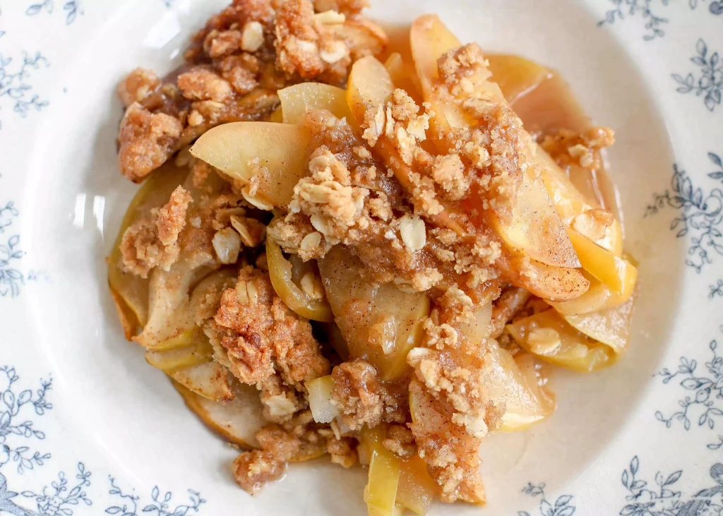 Apples and oats in a white bowl