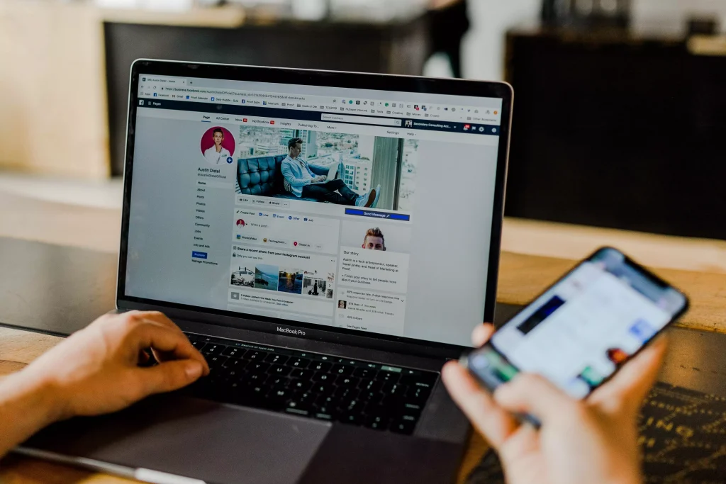 A social media expert working with his laptop and phone