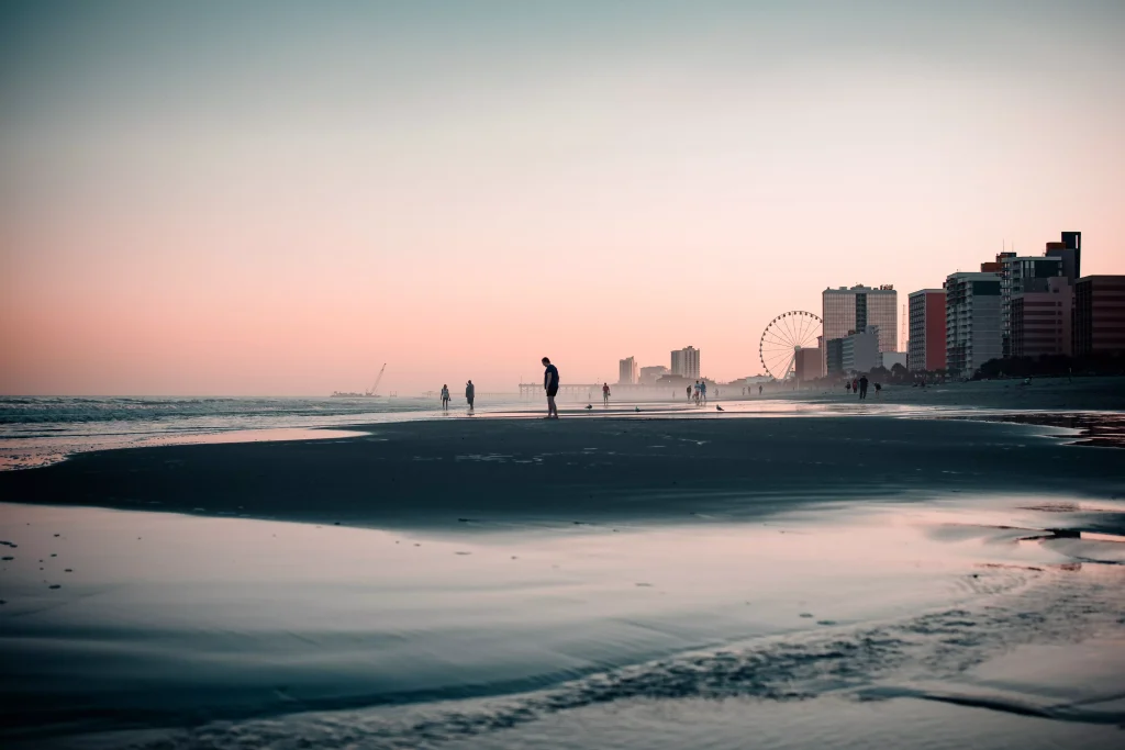 Beach with people photographed before night