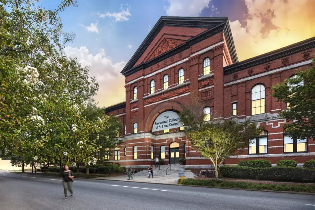 Brown building of bricks and trees infront of it