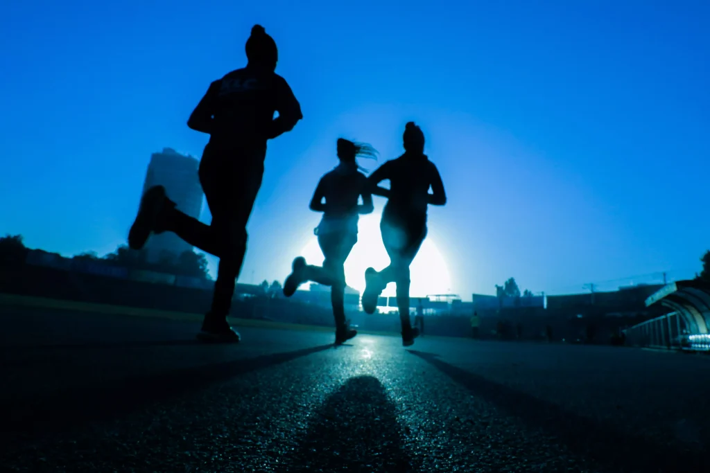 Three women runing in then phoographed from the frog perspective