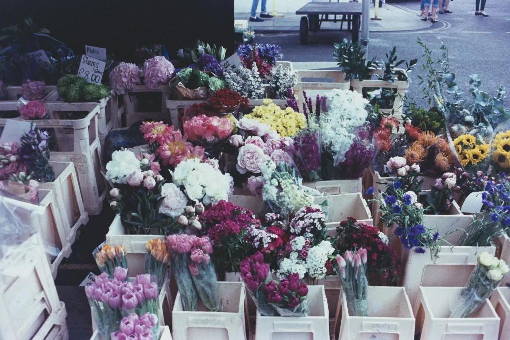 Yellow red pink green flowers put together in bouquets and displayed for selling