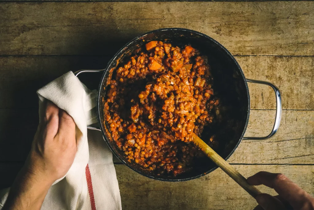 Healthy meal with lentils being stired.