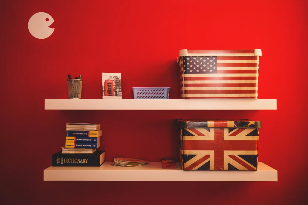 Open shelving on red wall with some accesories and books placed on top of it