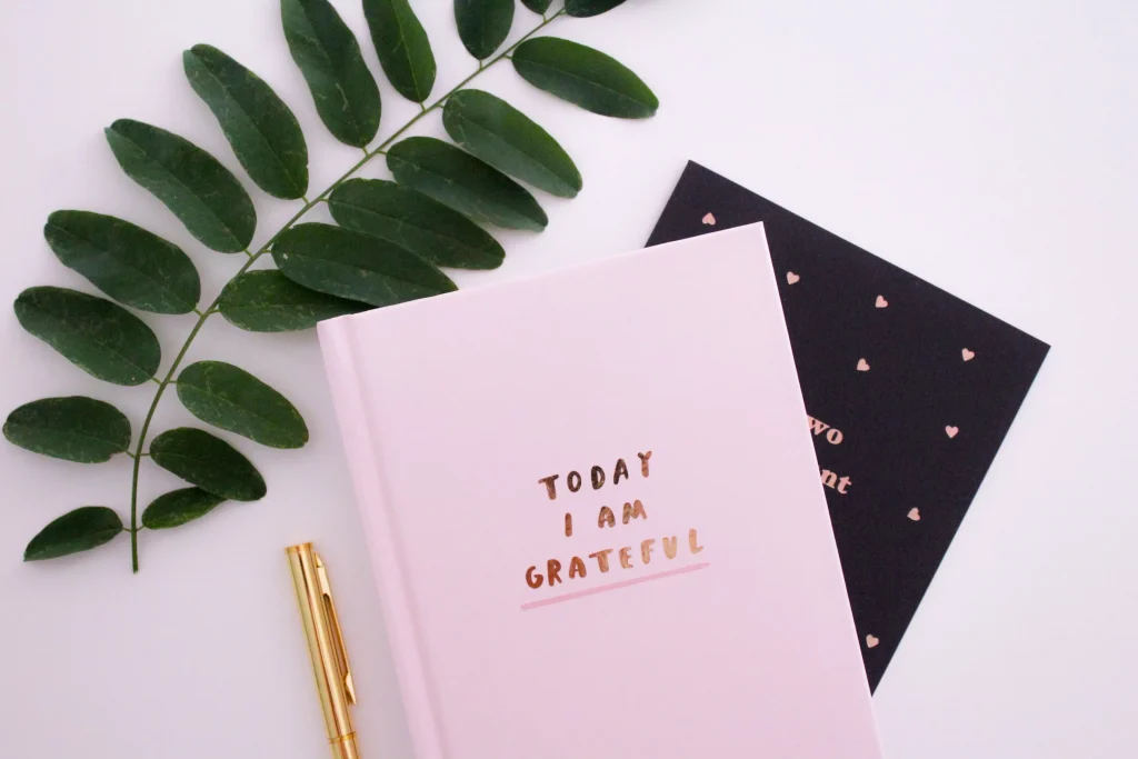 A pink notebook that says on the cover "Today I am Grateful"