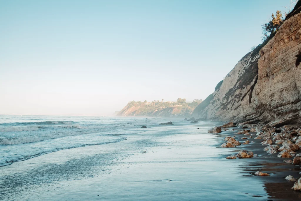 a beach near cliffs