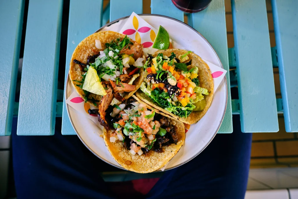 Tacos arraneg in a bowl on a blue table