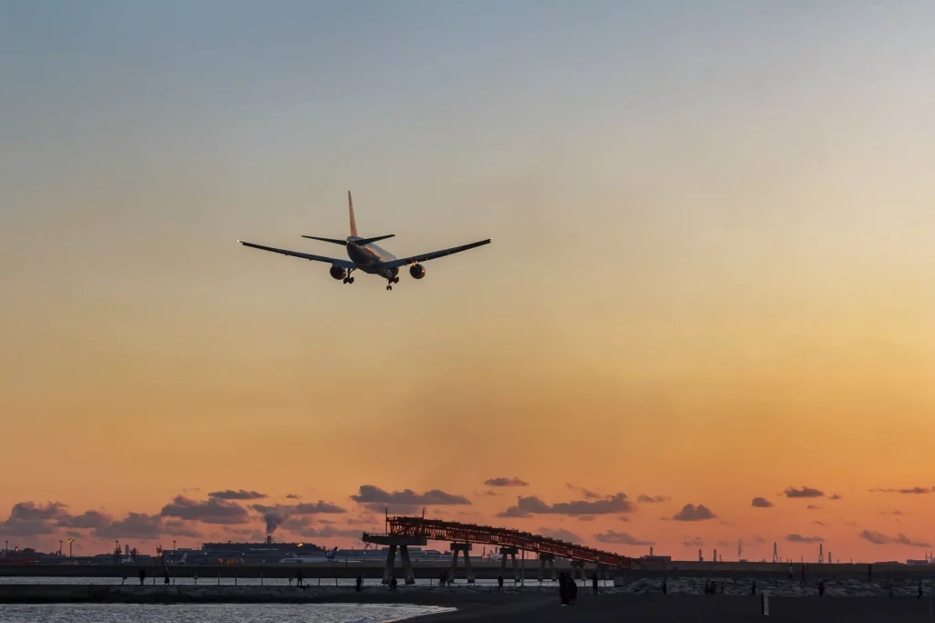 Airplane flying into the sunset