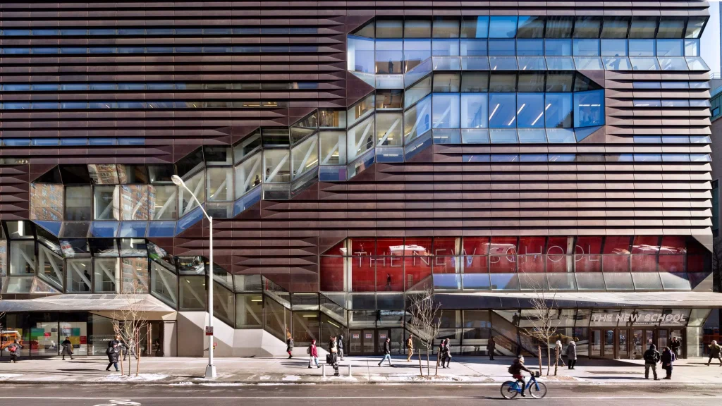 A glass building with people infront of it