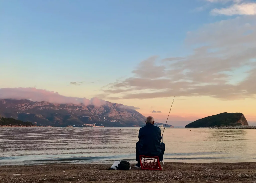 Man fishing with beautiful sky above him