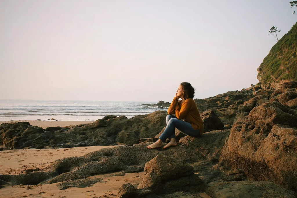 Women siting on beach and thinking