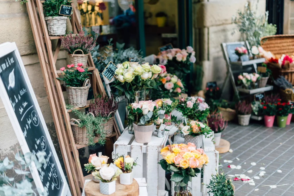 Yellow flowers arranged next to a board on which is written with chalk 