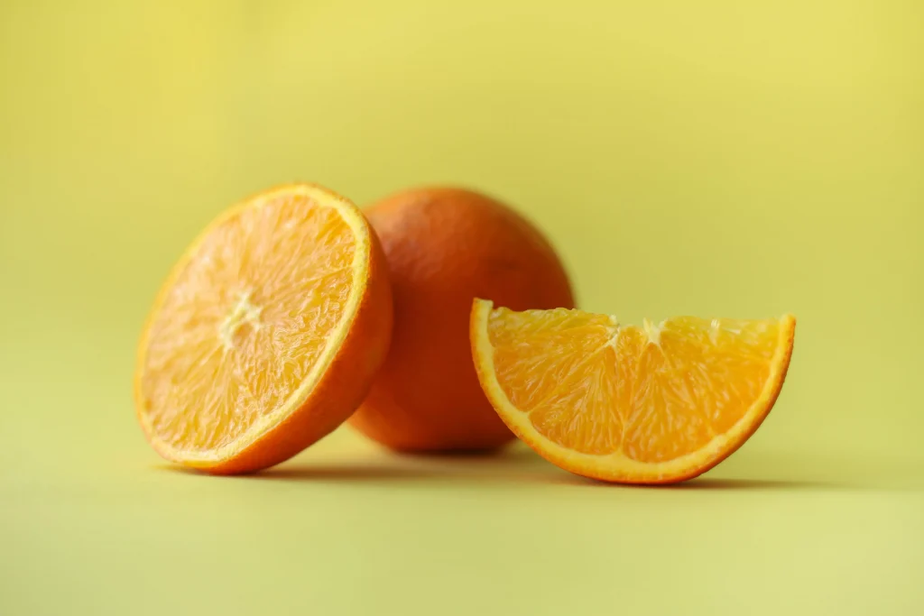 A whole orange and a slice orange picture