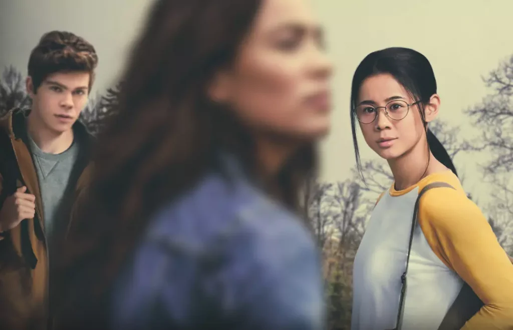 a girl in glasses in a yellow t shirt watches a girl in a blue shirt