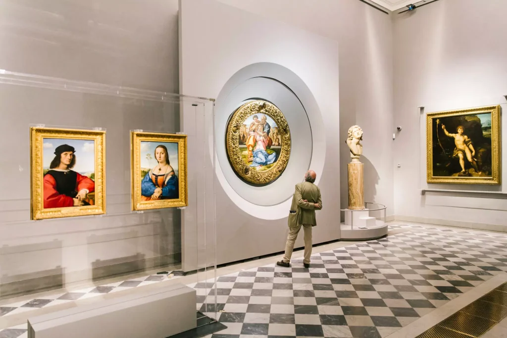 man looking at a painting in a museum