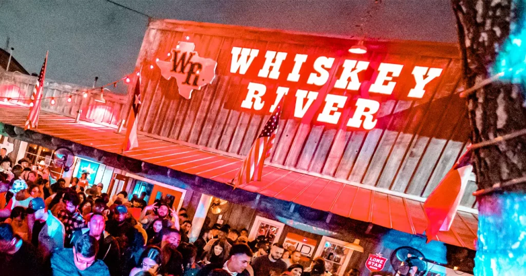 an entrance to a club with neon lights shining