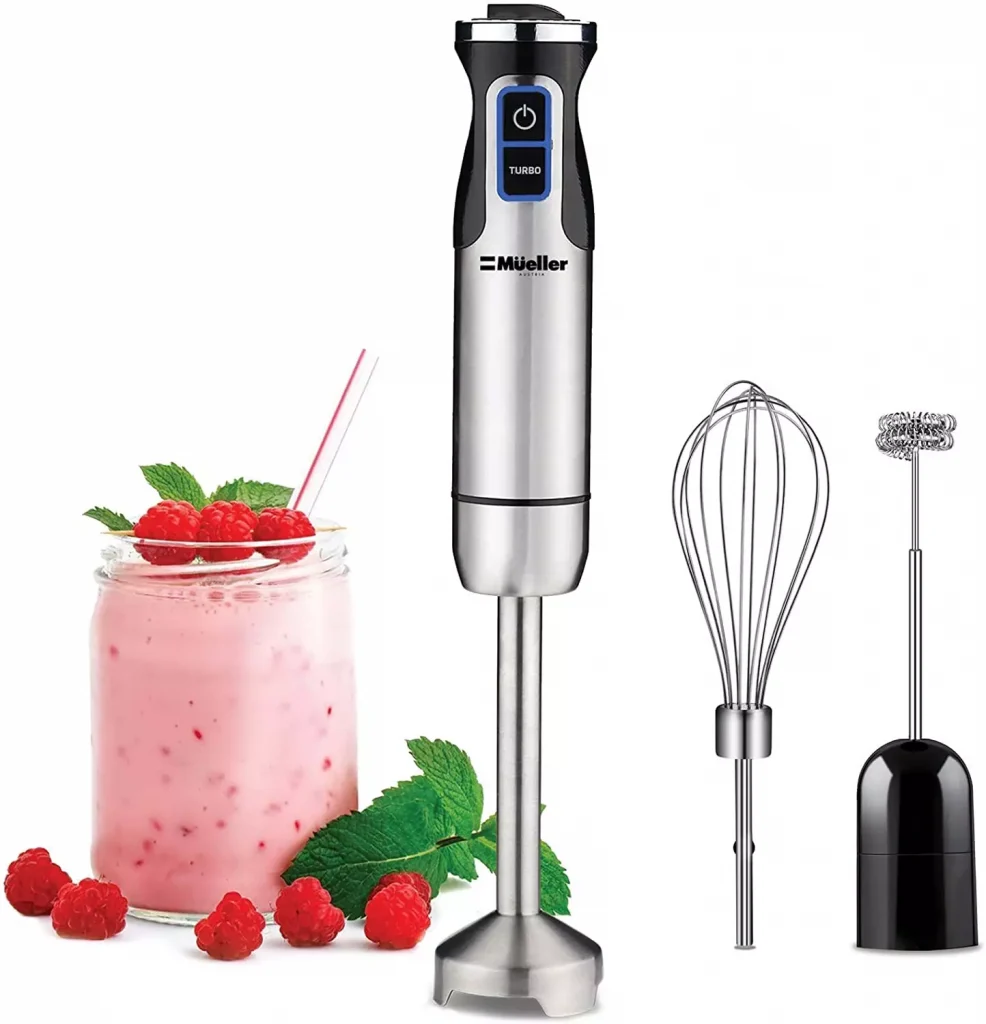 a strawberry shake in a glass next to some kitchen gadgets