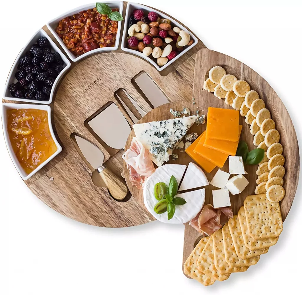 a wooden plate filled with cheese and nuts