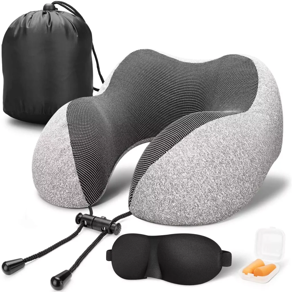 a grey travel pillow with a headband for sleeping next to it