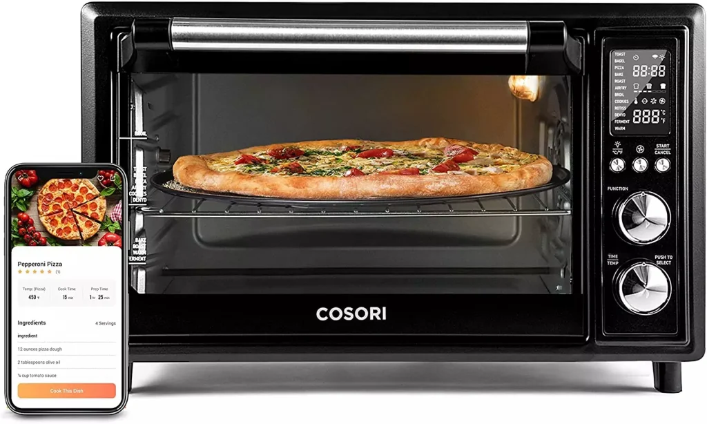 microwave with a pizza inside next to a smartphone