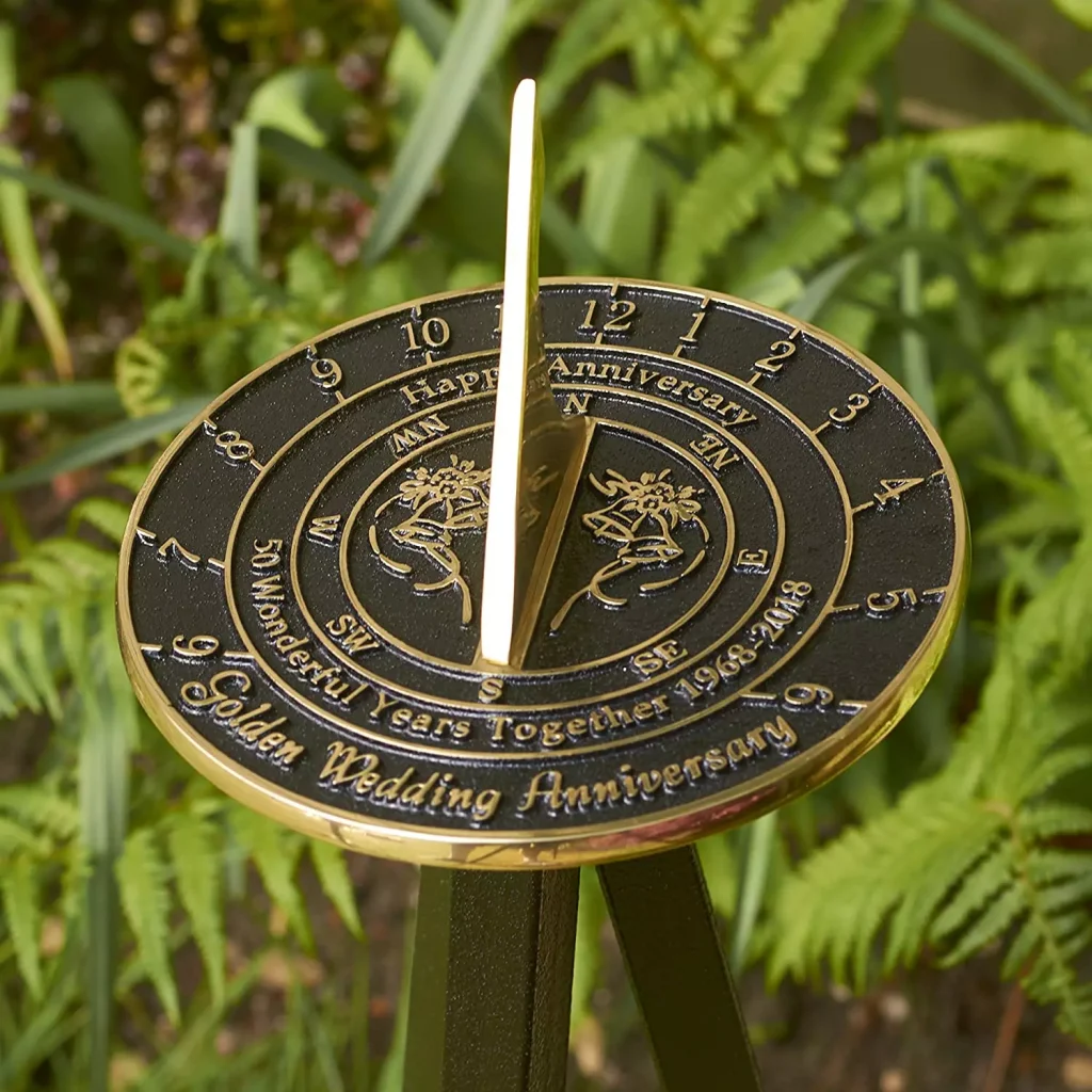 a golden clock outside on grass