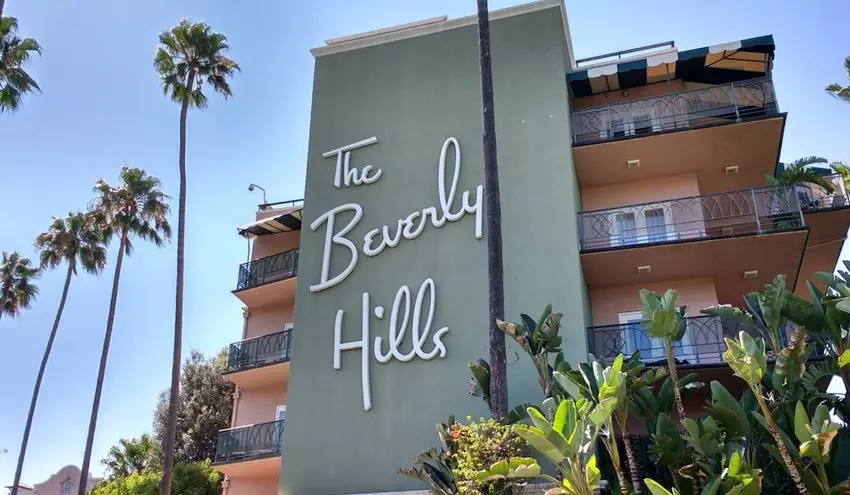 a grey sign which says "The Beverly Hills"