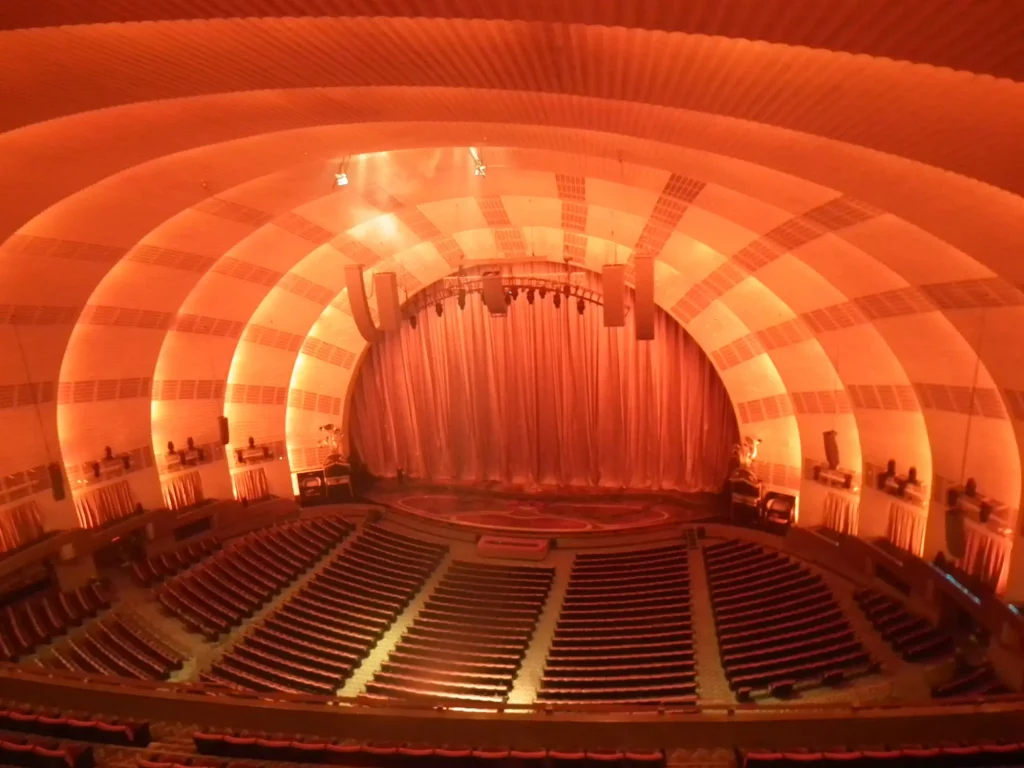 a stage for music performers with red lights