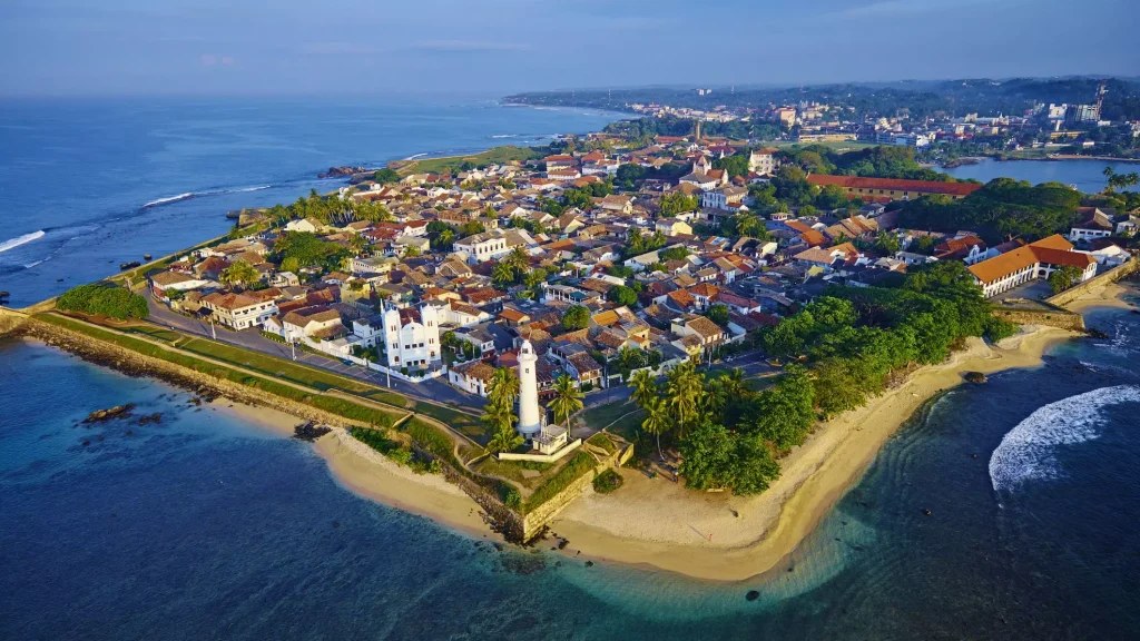 little island city with green fields and beaches photographed from the sky