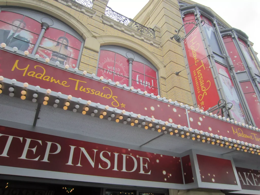 yellow building with red posters all over it