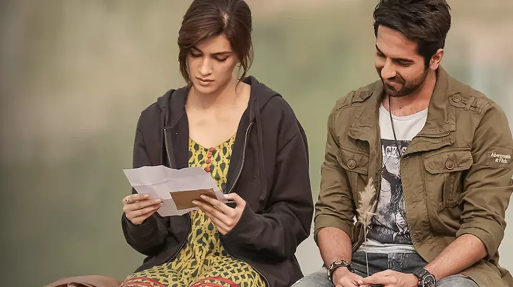 a guy next to a girl who is reading a letter