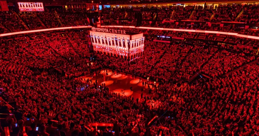 inside of an basketball arena with a lot of people in red lights