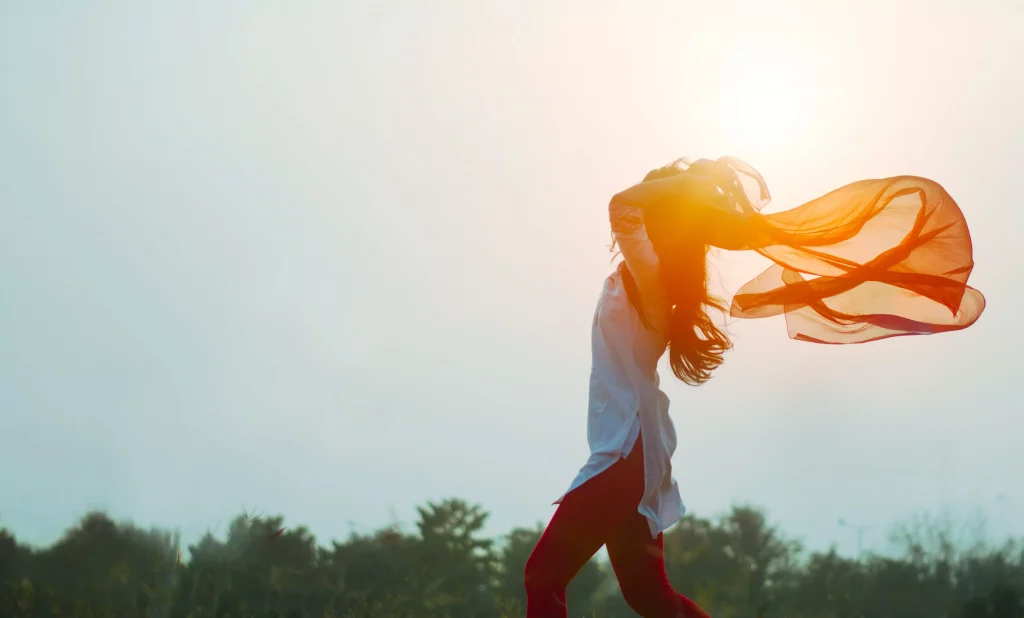 girl with white top and red pants enjoying the sun