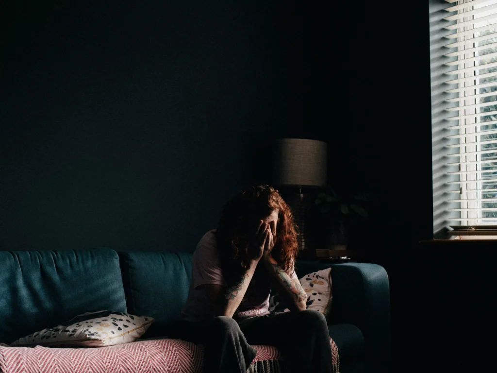 girl in a white top sitting on a couch