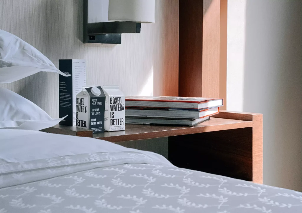 a hotel desk with books and water on it