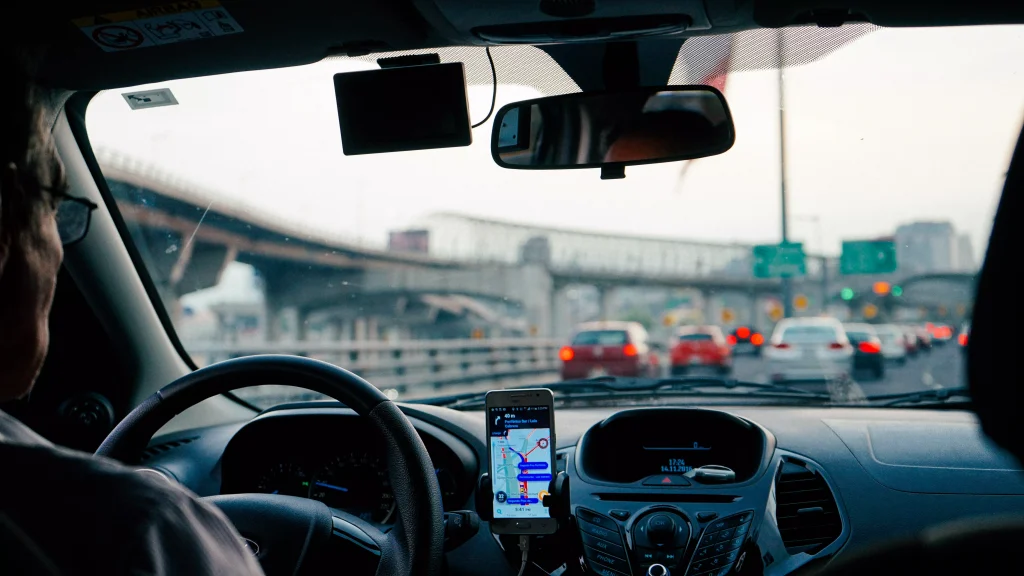 a taxi driver photographed from the rear seat in the car