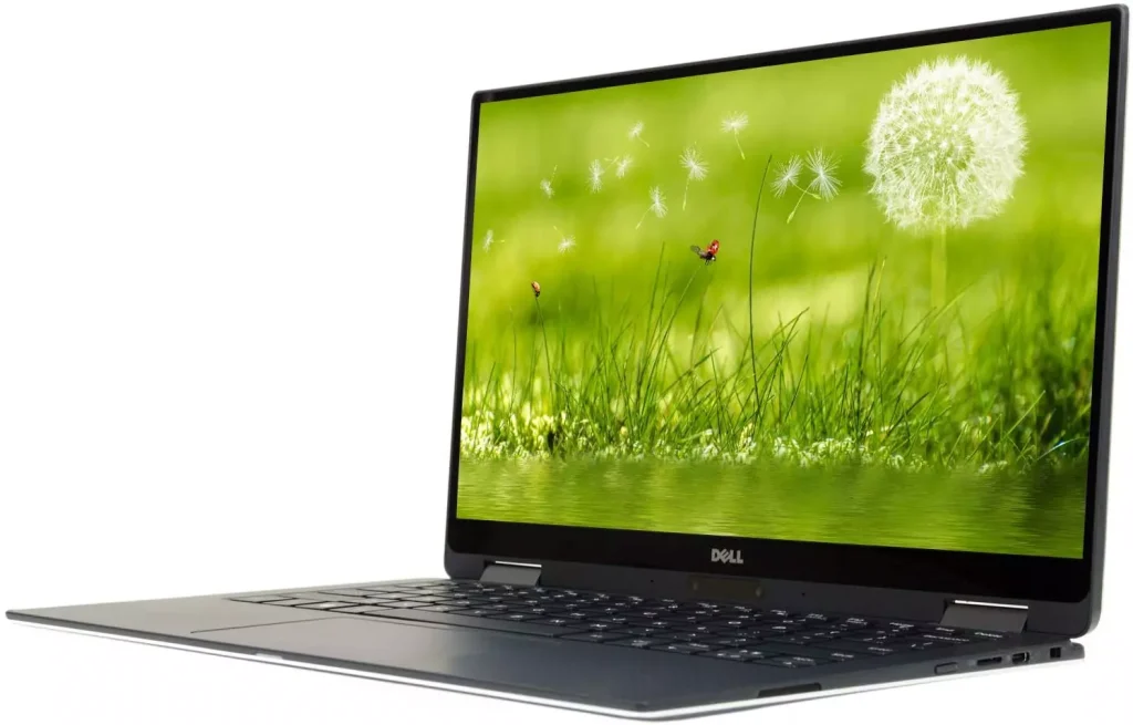 a laptop photographed from the side with a green background