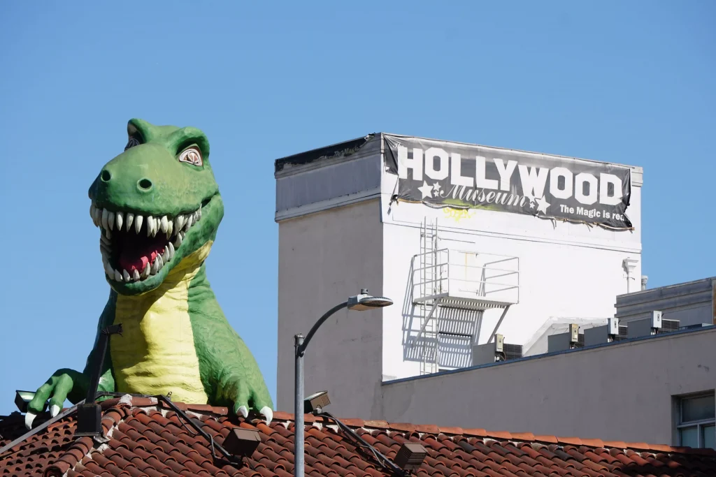 a big green baloon next to a white building