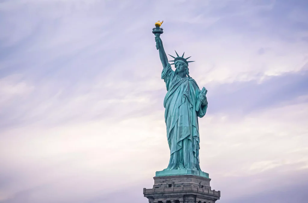 a blue statue holding a torch