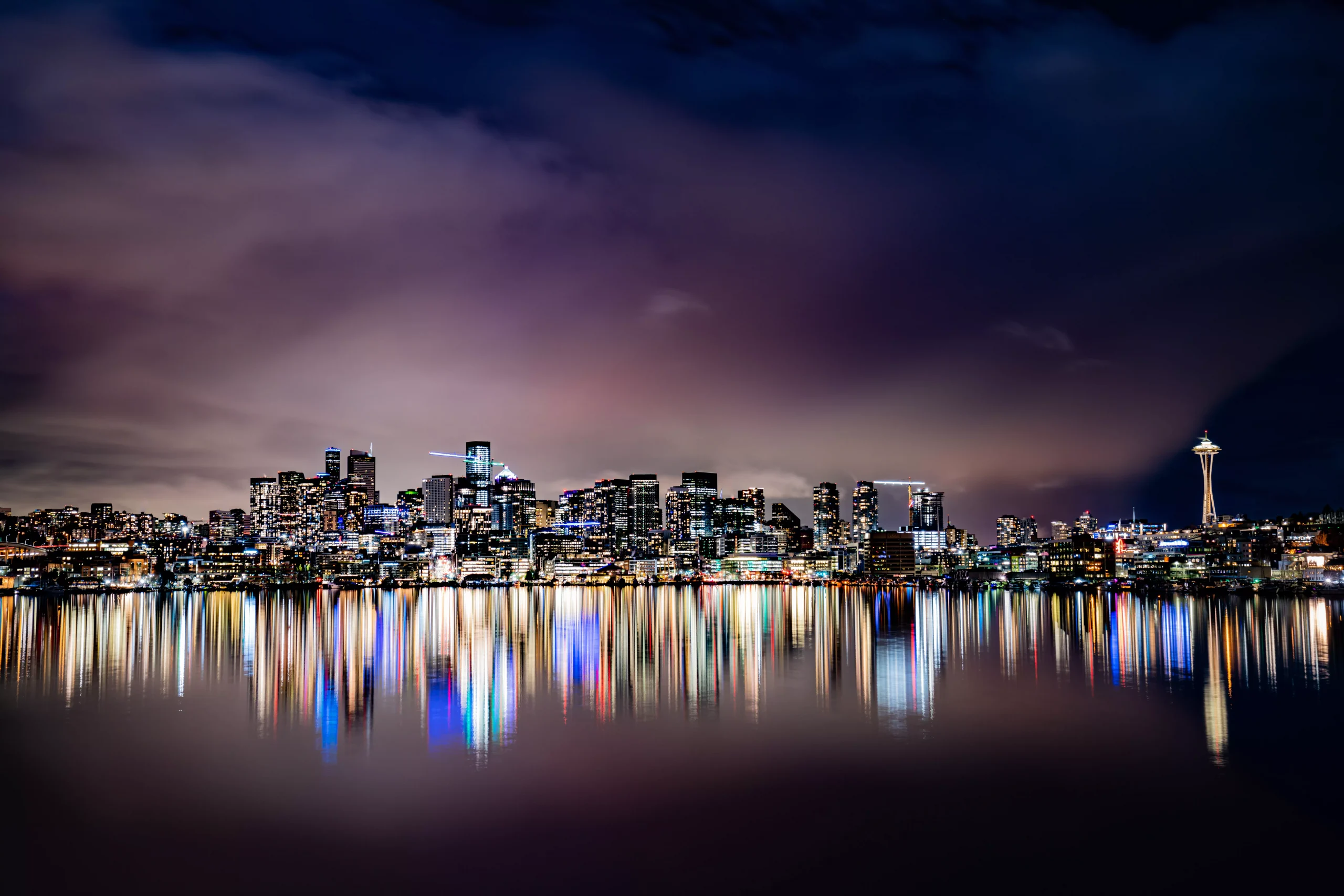 a city photographed during night time from the river