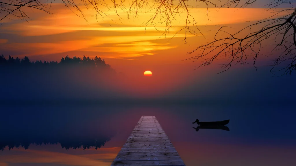 a sunfall leaving a reflection on a beautiful lake