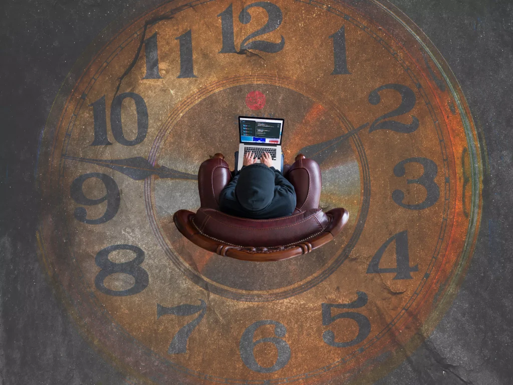 man siting in a arm chair working on his laptop